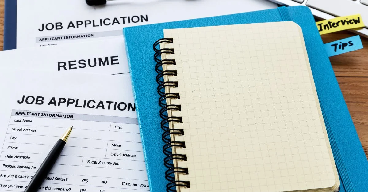 Job market right now, job application, resume and interview notes on a desk