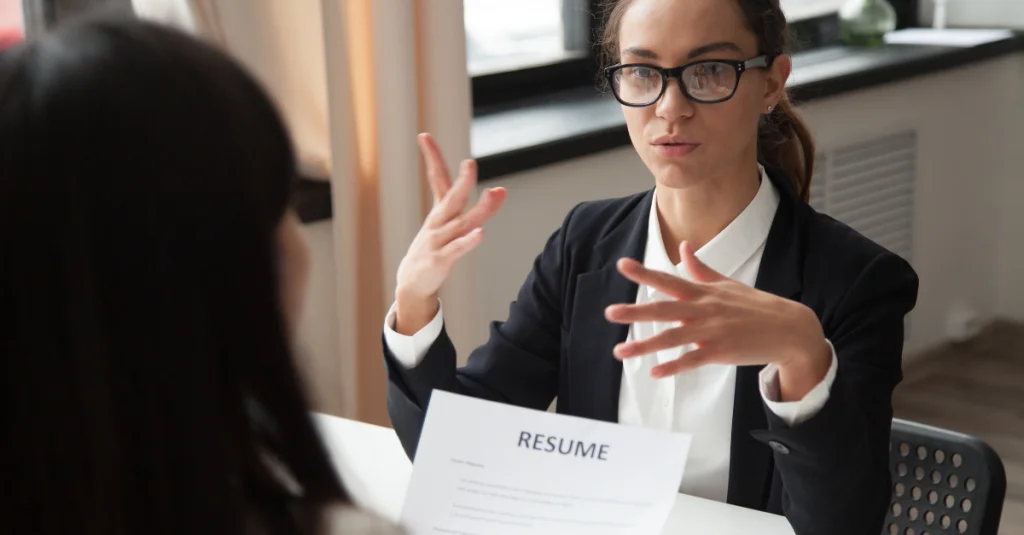 Professional woman using confident body language during a job interview.